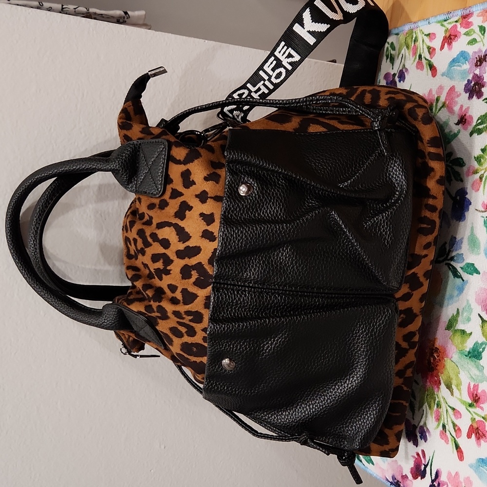 Purse that can be an over the shoulder, handheld or crossbody.